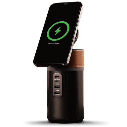 Image of the power station with a phone wirelessly charging on top and the lid tilted up.